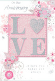 In this image, an anniversary card unfolds like a gentle tribute to enduring romance, its design combining soft pastel pinks and silvery greys that create an atmosphere of quiet intimacy. At the centre of the card, the word "LOVE" is spelled out in prominent raised letters, each stroke softened by a veil of fine glitter that adds shimmer without harsh sparkle. The letter "O" is cleverly transformed into a shimmering heart shape, filled and edged with a slightly denser silver texture, so that it looks like a delicate charm set among the lighter blush tones. This textured focal point invites touch, suggesting the same sense of closeness as holding hands on a peaceful walk through nearby Friary Park. Flowing out from the central word, delicate blooms in blush, mauve, and ivory unfurl with a watercolour softness, their edges gently blurred and shaded, as though painted in light washes. The flowers are intertwined with slender stems and flourishes that curl and loop in graceful patterns, echoing the curves of hand-tied anniversary arrangements displayed in local North Finchley shops. Tiny details-scattered petals, swirling tendrils, and ethereal butterflies-add a subtle sense of motion, as if a soft breeze had just passed across the card. Above and below the floral frame, the phrases "On Our Anniversary" and "I love you today and always" appear in an understated, flowing script that feels sincerely handwritten, not overly formal. The overall composition is balanced and soothing, the pastels and silver accents working together to create a keepsake that feels as tender and heartfelt as a carefully chosen bouquet delivered to a doorstep off Ballards Lane to celebrate another year shared together.